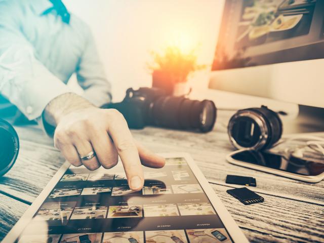 photographer journalist camera traveling photo dslr editing edit hobbies lighting business designer concept - stock image NOTE TO INSPECTOR: All visible photos were produced for this particular shoot. I am the author of everything that you see in the image (interface program on the screen - property release added).